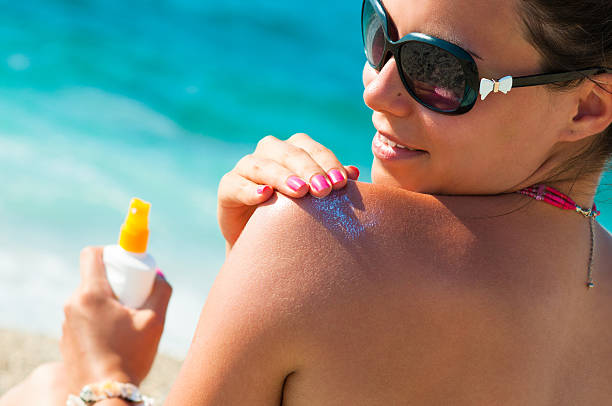 istock Beautiful young woman applying lotion on her back 174073131