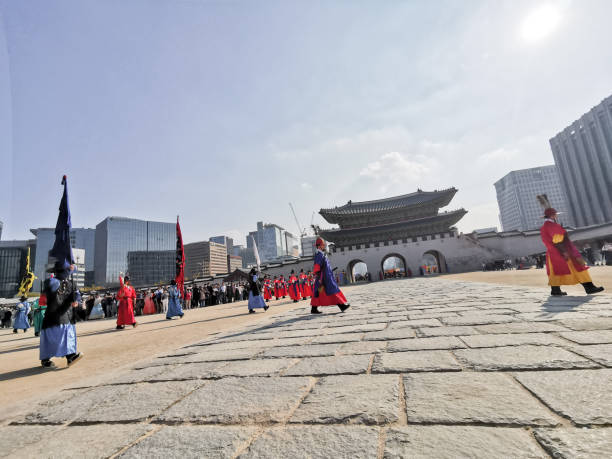 Seoul, South Korea - October 27, 2022: Korean ancient old soldier warriors guard changing event among many tourists in Gyeongbokgung Palace front ground.