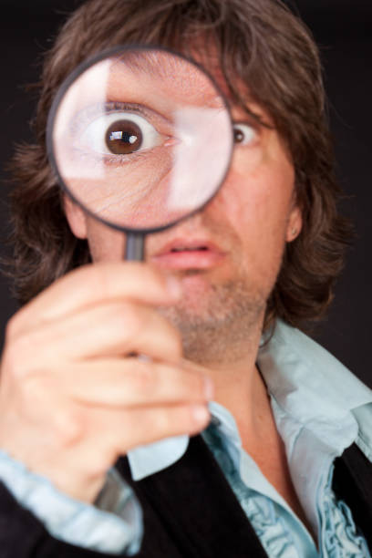 istock Surprised man holding a loupe 174074259