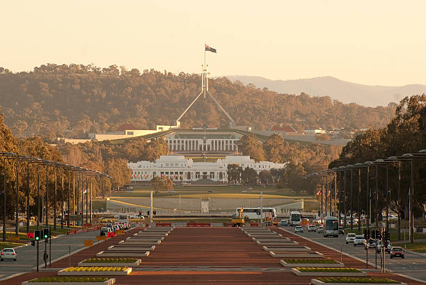 Canberra - Old and New Parliament Houses "The old and new parliament houses of Australia, seen down Anzac Parade in Canberra around  sunset." canberra photos stock pictures, royalty-free photos & images