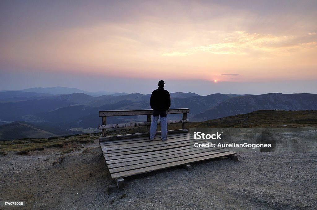 Young man wathcing sunset over the mountains "Young man wathcing sunset over the mountainsYou can find all the images below in the same lightbox, I dare you to take a pick:" Adult Stock Photo