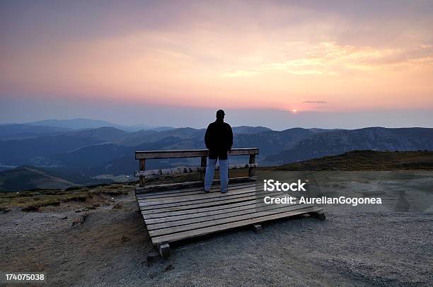 Young Man Wathcing Sunset Over The Mountains Stock Photo - Download Image Now - Adult, Cloud - Sky, Cloudscape