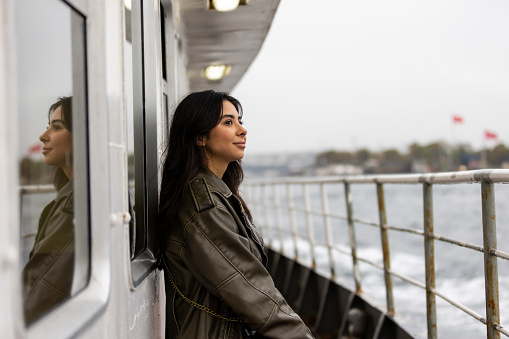 Pretty young tourist lady is traveling around Bosphorus.
Istanbul - Turkey.