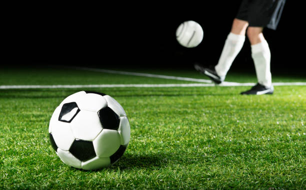 istock Football on the grass at night 174077061