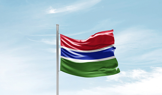 flag of gambia waving in beautiful clouds.