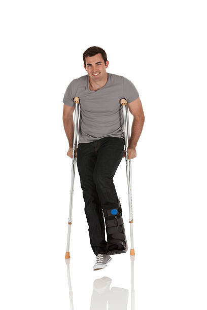 istock Injured man walking with the help of crutches 174077377