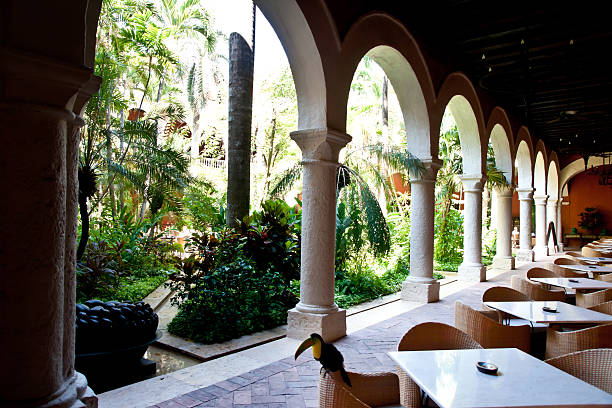 istock colonial architecture: lush courtyard with tables around it 174077451