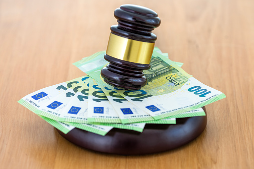 Judge or Auctioneer Gavel On 100 Euro Cash, Close-Up. Concept for corruption, bankruptcy, auction crime, fraud, fines