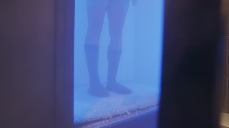 Young Adult Entering a Cryotherapy Chamber