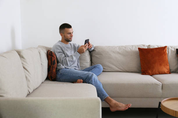 istock Mid adult man typing on his phone. 1740776471