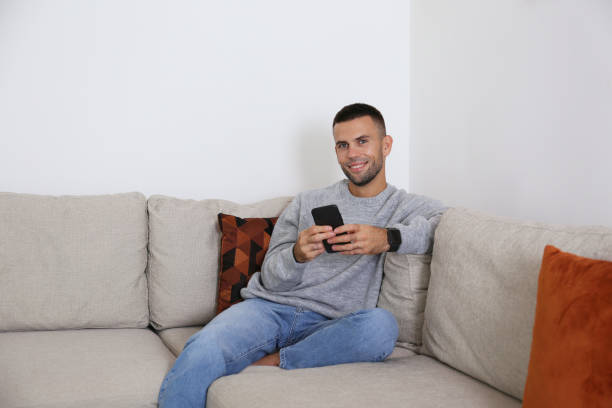 istock Mid adult guy laughing at his phone. 1740780425