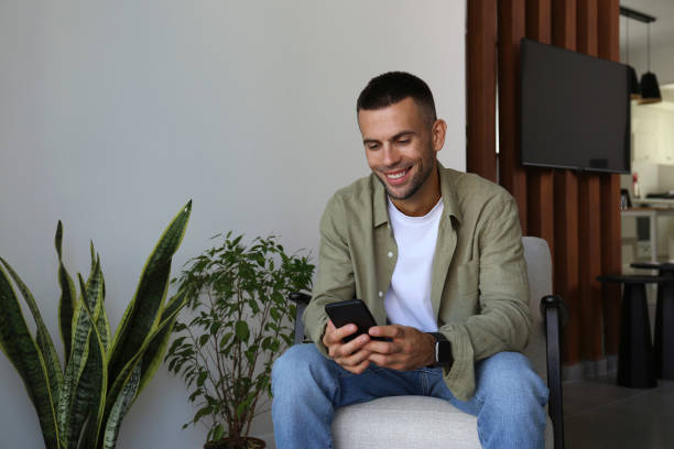istock Mid adult guy laughing at his phone. 1740786877