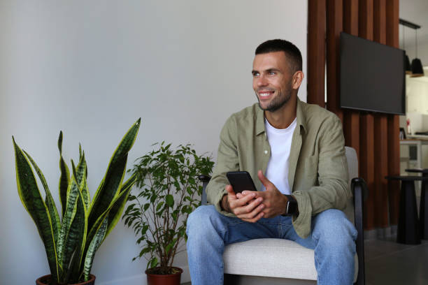 istock Mid adult guy laughing at his phone. 1740786894