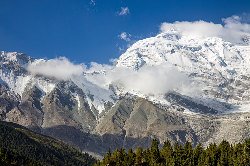 XXXXL size panorama of Mount Ama Dablam - probably the most beautiful peak in Himalayas. \n This panoramic landscape is an very high resolution multi-frame composite and is suitable for large scale printing\nAma Dablam is a mountain in the Himalaya range of eastern Nepal. The main peak is 6,812  metres, the lower western peak is 5,563 metres. Ama Dablam means  'Mother's neclace'; the long ridges on each side like the arms of a mother (ama) protecting  her child, and the hanging glacier thought of as the dablam, the traditional double-pendant  containing pictures of the gods, worn by Sherpa women. For several days, Ama Dablam dominates  the eastern sky for anyone trekking to Mount Everest basecamp