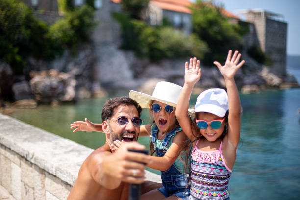 istock Father with daughters taking selfie on Saint Szefan at Montenegro 1740789803
