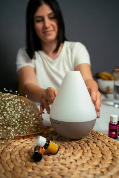 istock Young woman preparing air diffusor, mixing essential oils 1740796933