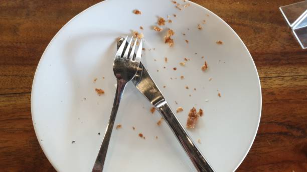 istock a white plate topped with a fork and a knife 1740812285