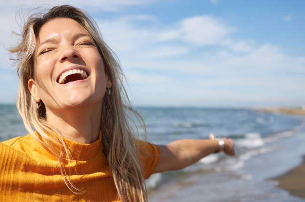 istock Happy woman enjoying day on a beach 1740822052