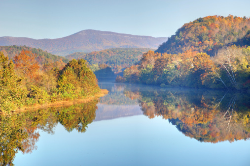 Early morning light reflecting  beautiful fall colors on the James River along the Blue Ridge Parkway in Virginia. Autumn foliage  along Blue Ridge Parkway and Blue Ridge Mountains of Virginia make the region one of the most beautiful places in the world. 