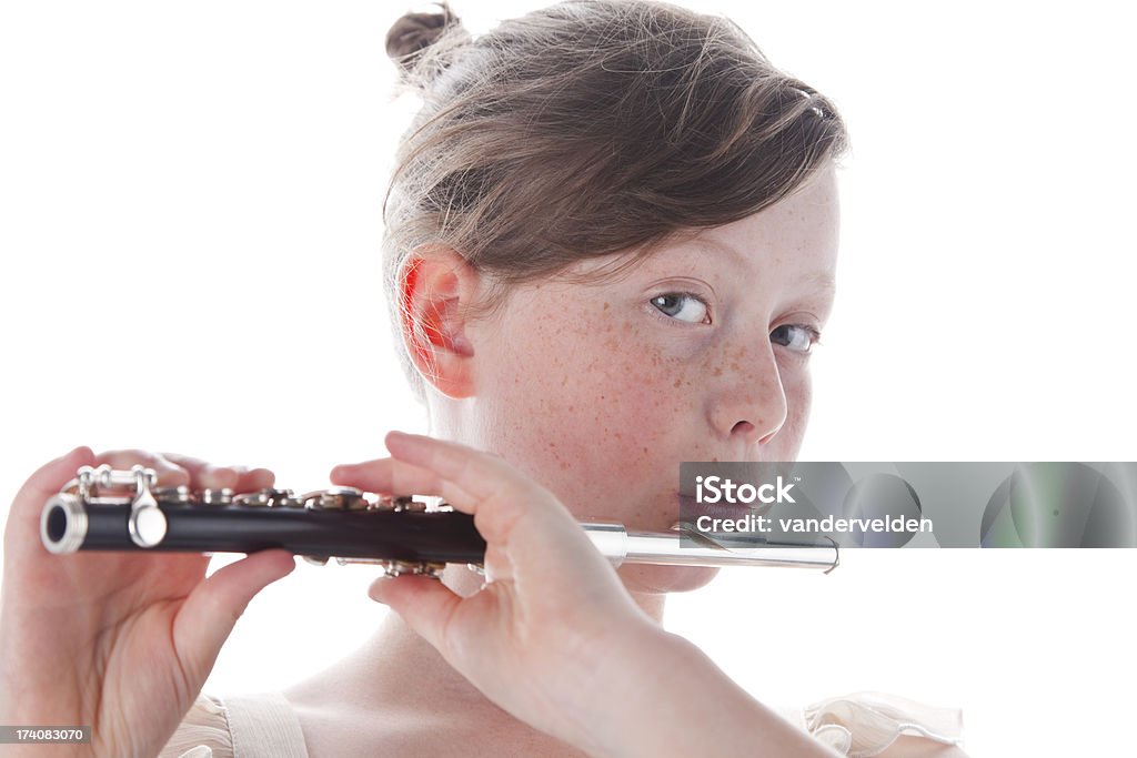 Cute Girl Playing Her Piccolo 10-year-old girl playing her piccolo - isolated on white in the studio. Piccolo Stock Photo