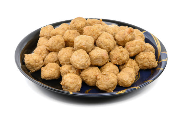 Meat or Fried Shrimp Balls placed in a black plate  isolated on white background.