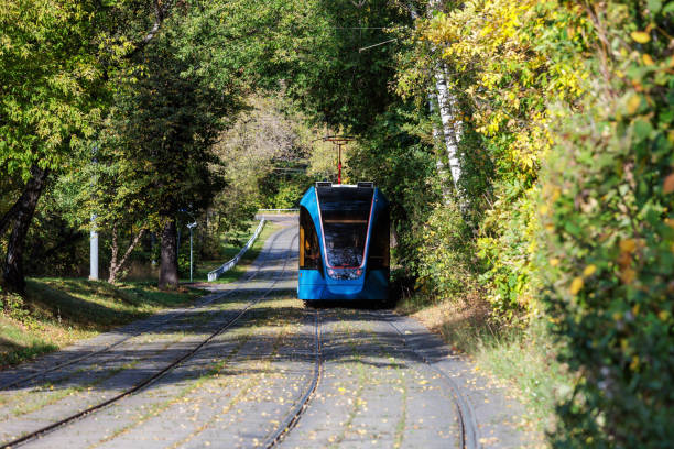 istock Tram on the road in the forest in autumn colors. 1740835521