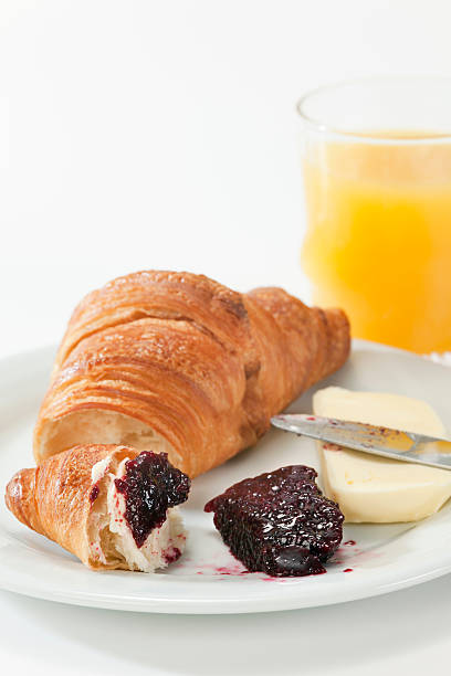 Breakfast with Croissant and Juice. Selective focus, shallow DOF.