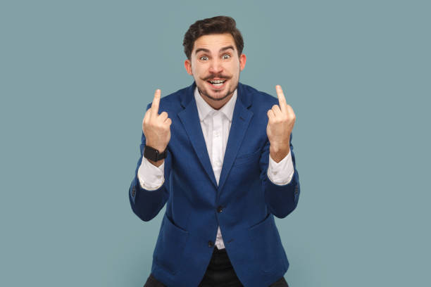istock Rude impolite handsome man standing showing middle fingers, looking at camera with clenched teeth. 1740855275