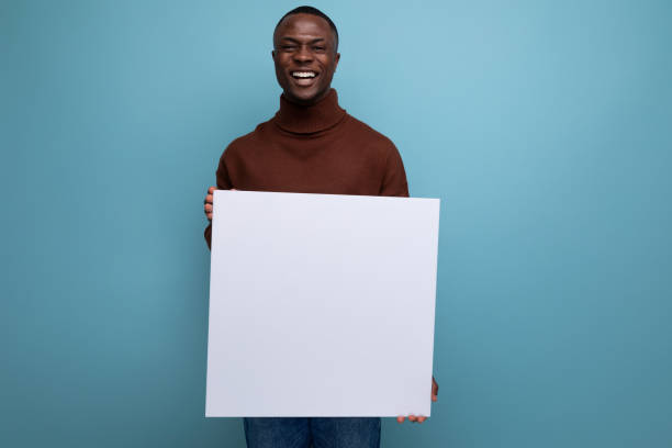 istock young african man advertise product with display on white sheet 1740856443
