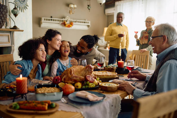 istock Cheerful multiracial family having fun while gathering for Thanksgiving at home. 1740857053