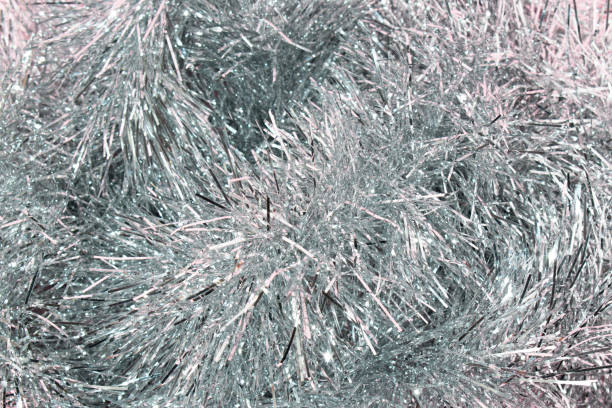 Shiny silver tinsel Christmas decoration. Holiday or celebration event concept.