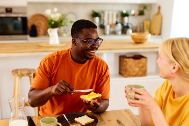 istock Multiracial couple enjoying breakfast together at home 1740871897