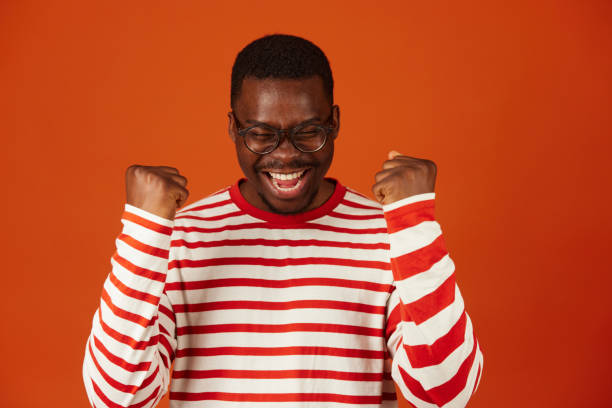 istock Black man making a winner's gesture with his hands clenched into fists 1740879920