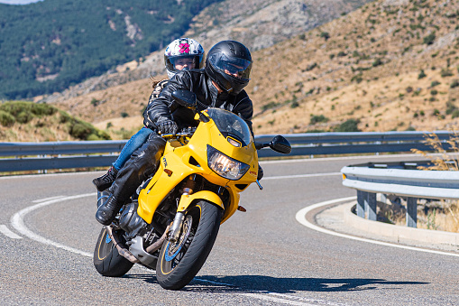 Motorcyclist taking a curve in the port of Navalmoral, province of Avila, Spain, during the month of September 2020