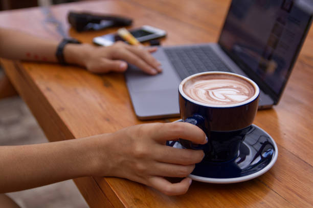 istock Women using laptop working and drinking coffee cup hot in the morning background 1740893065