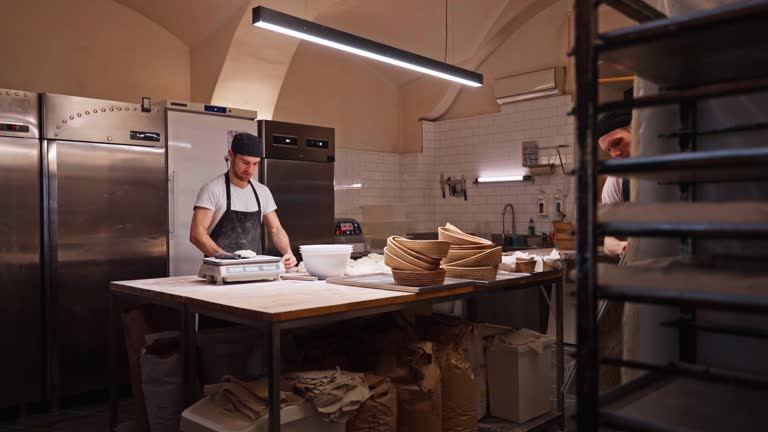 Artisan Bakers Preparing For Baking Stage In A Small Bakery