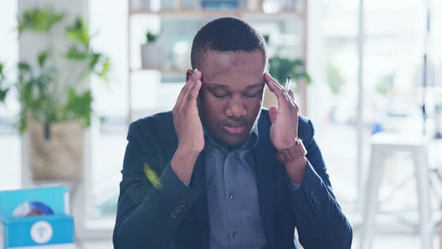 Black man, headache and pain in office, stress and mental health in crisis, brain fog or fail. Frustrated male worker, migraine and massage temple for anxiety, burnout or fatigue problems in business