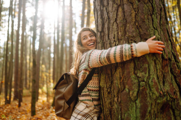 istock Beautiful young tourist with a backpack is having fun in the autumn forest. 1740899194