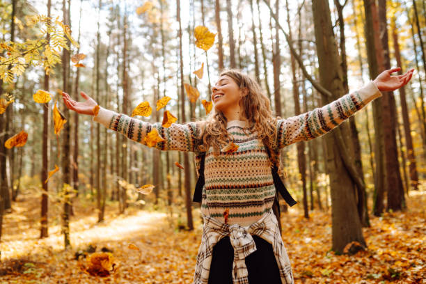 istock Beautiful young tourist with a backpack is having fun in the autumn forest. 1740899214