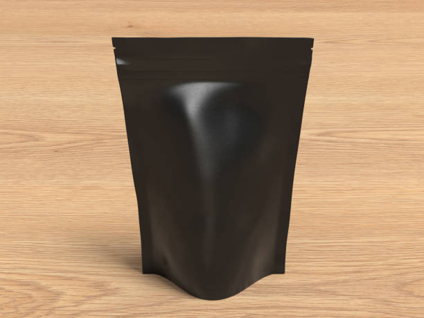 istock Black packaging pouch mockup for tea, coffee, snack on wooden background 1740907177