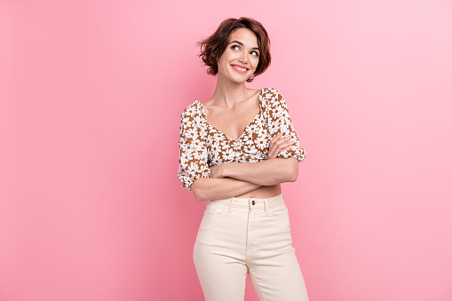 Portrait of positive stunning lady toothy smile folded arms look empty space ad brainstorming isolated on pink color background.