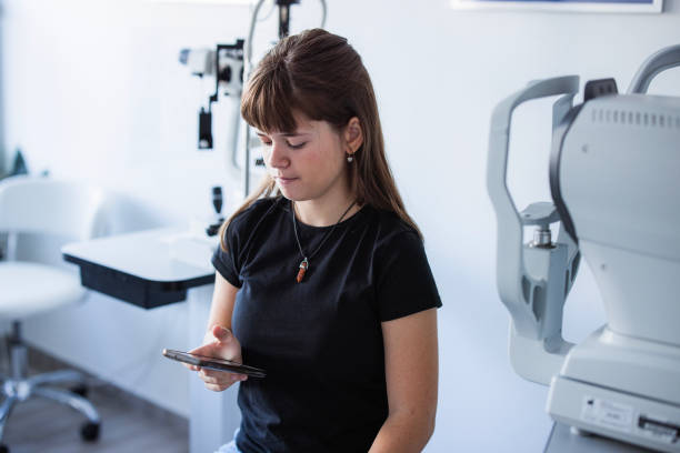Girl sitting at doctor's office and checking messages