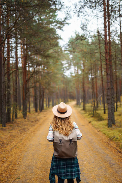 istock Beautiful woman in a hat with a backpack on a nature hike. 1740908330