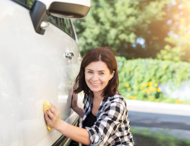 istock Woman with rag next to car 1740915242