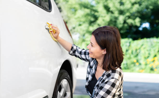 istock Woman using rag for wiping car 1740915245