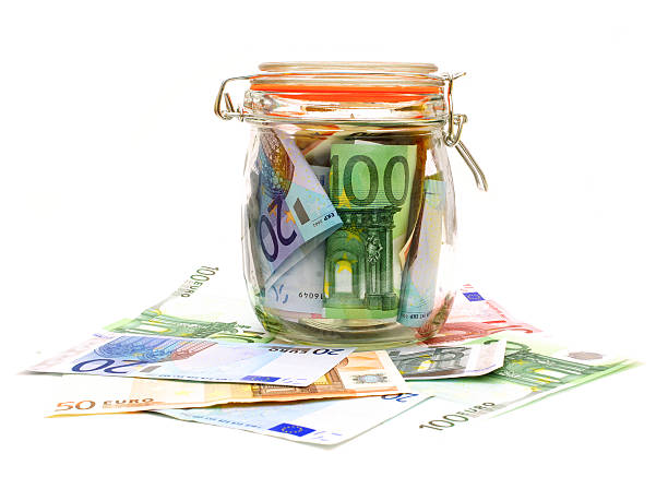 istock Jar of money with scattered notes 174091749