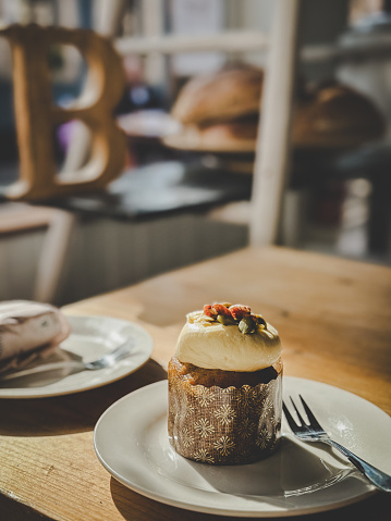 Pumpkin and walnut cupcake with nuts, seeds and cream cheese frostin