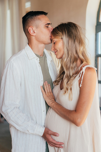 Loving married couple hugging. Pregnant woman and partner.