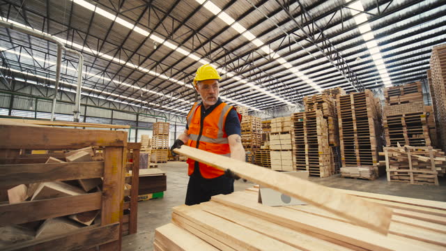 Carpenter inspects the quality of transformed wood products to be complete for export and processed into other furniture