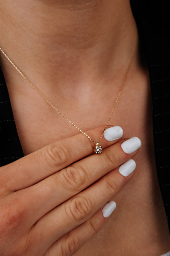 Close up necklace on necklace girl's neck. Beautiful woman wearing black jacket style with diamonds, six, diamond necklace, luxury fashion jewelry